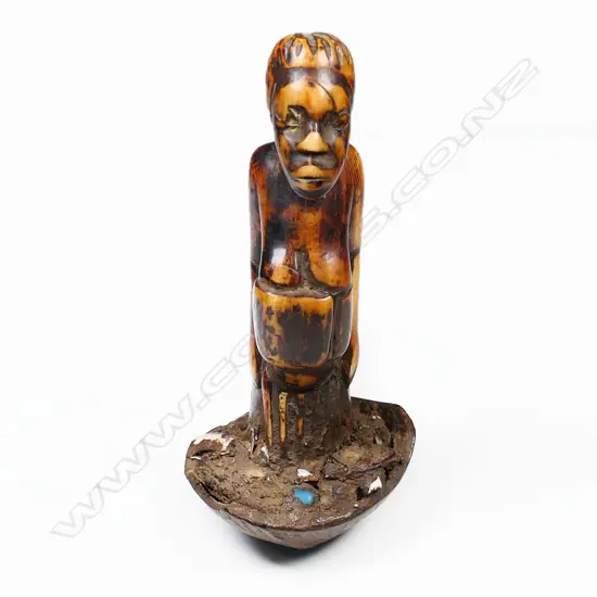 An African carved ivory fetish figural pestle,